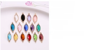 Detail of 9x21mm colorful marquise crystal charms with double loops in gold plated copper