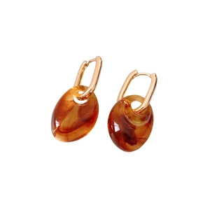 Retro amber acrylic round drop earrings with gold metal clasp on white background
