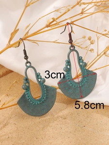 Close-up of bohemian carved fan earrings showing dimensions 5.8cm height and 3cm width