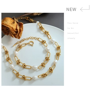 Detailed view of gold plated twisted chain necklace set with baroque freshwater pearls