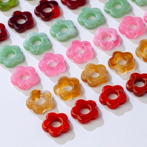 Detail view of colorful acrylic flower pendants for DIY earrings and hair accessories