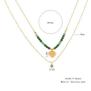 Detail showing stainless steel necklace size specs, green beads and gold heart charm