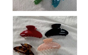 Detailed close-up showing various colors of large glossy acrylic shark hair clips