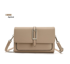 Detail view of apricot crossbody bag with woven texture flap and silver metal lock closure