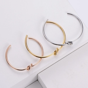 Minimalist knotted open cuff bracelet set in rose gold, gold, and silver finishes
