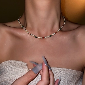 Close-up of a colorful baroque freshwater pearl and beaded necklace on a model's neck