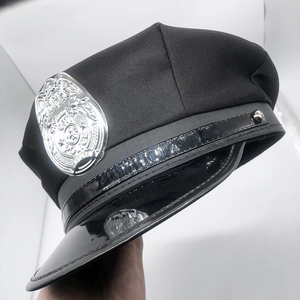 Classic black police hat with silver metal badge and glossy patent leather brim