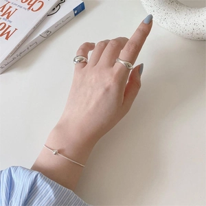 Minimalist S925 sterling silver ball snake chain bracelet worn on hand with silver rings