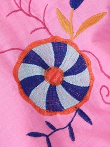 Detailed embroidery of floral patterns on pink cotton linen fabric for women jackets