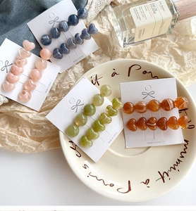 Detail of colorful resin heart hair clips with jelly texture and marble patterns