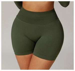 Detail of high-waist ribbed waistband on seamless dark green compression yoga shorts