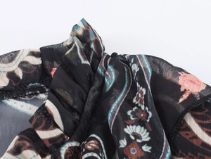 Close-up of lightweight paisley chiffon fabric with elegant floral ruffles and fine stitching