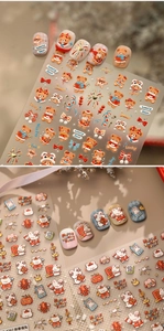 Close-up of cute rabbit and bear nail art stickers with festive New Year symbols