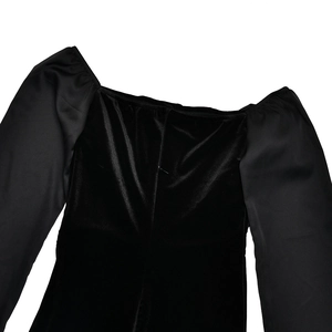 Detail of square neckline with velvet body and satin puff sleeves on a black dress