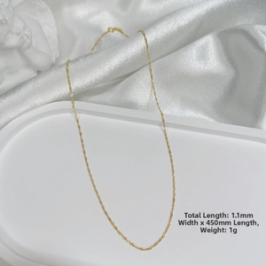 Detailed macro shot of 1.1mm wide S925 silver gold plated chain on white silk