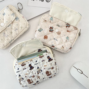 Flat lay of quilted mini card holders showing internal slots and cute animal patterns