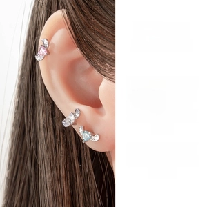 Detail of angel wing heart cartilage studs with pink, clear and blue zircons