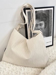Minimalist beige pleated canvas shoulder bag with adjustable strap for daily commute