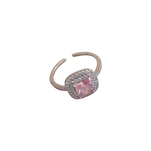 Adjustable silver crown ring with a square pink zircon center stone on white background