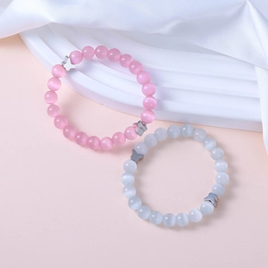 Pink and white cat eye bead bracelets with silver butterfly charms on silk