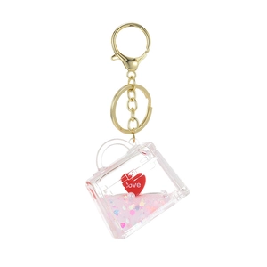 Pink quicksand oil bottle keychain in handbag shape with love heart and gold ring