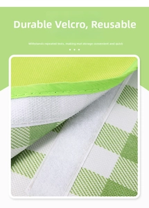 Close-up of durable velcro closure on green and white checkered waterproof picnic mat