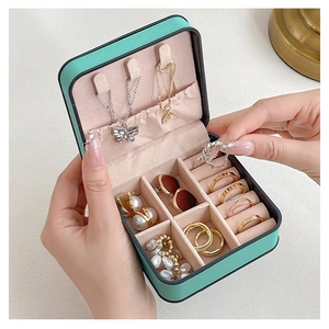 Detail view of lake blue jewelry box showing ring slots and necklace storage
