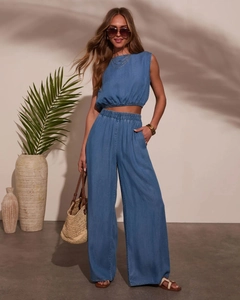 Détail d'un ensemble deux pièces en denim bleu avec haut court et pantalon large