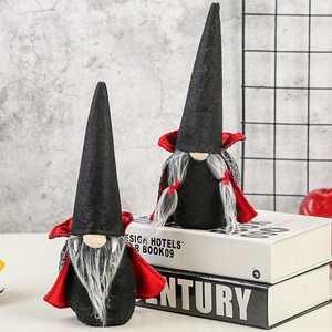 Halloween vampire gnomes set with black hats and red capes on decorative display