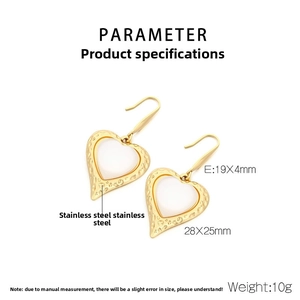 Detailed view of 28x25mm gold heart earrings with hammered texture and cat eye inlay