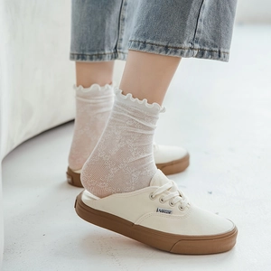 White lace mesh socks with ruffle cuffs styled with canvas shoes and denim jeans