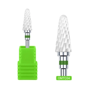 Detailed view of white ceramic corn head nail drill bit with a green safety ring base