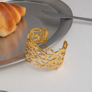 Macro shot of branch-like coral texture on 18K gold plated stainless steel cuff
