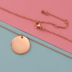 Polished rose gold stainless steel round pendant necklace with lobster clasp and chain detail
