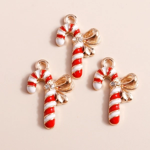Close-up of red and white candy cane pendants with gold bows and sparkling rhinestones