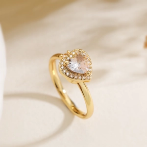 Macro detail of 18K gold plated heart ring featuring a large sparkling cubic zirconia