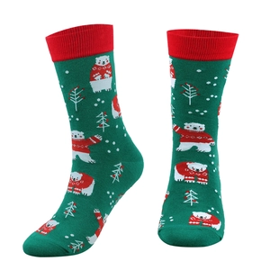 Detail of forest green Christmas crew socks with polar bear patterns and red ribbed cuffs