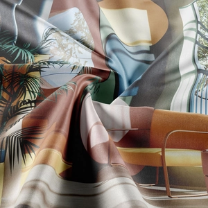 Detail of bohemian printed fabric with palm leaves and smooth silk-like texture with drapes