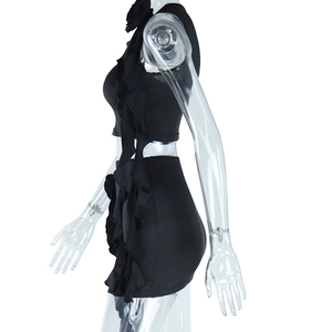 Detail view of black bodycon set featuring 3D ruffled trim on crop top and mini skirt
