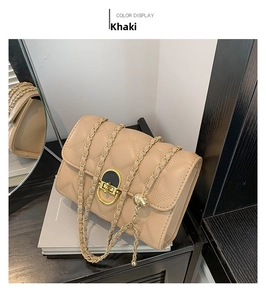 Detailed macro view of khaki quilted crossbody bag with gold chain and star pattern