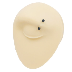 Macro view of silicone eye model with black ball eyebrow piercing for training