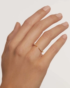 Detail of adjustable gold S925 silver ring with zircon accents on model finger