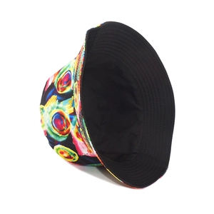 Detail of reversible bucket hat showing colorful abstract print and solid black inner lining