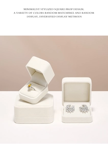Macro view of minimalist white velvet jewelry boxes for rings and earrings display