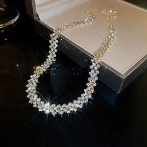 Close-up of sparkling multi-row rhinestone choker necklace in a beige jewelry box
