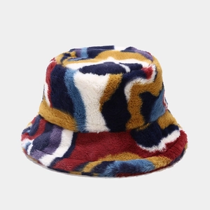 Detail of colorful tie-dye faux fur bucket hat with soft plush texture and vibrant hues