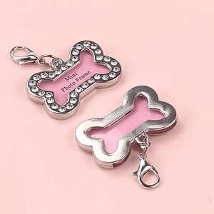 Pink bone-shaped pet ID tag with sparkling rhinestones and mini photo frame