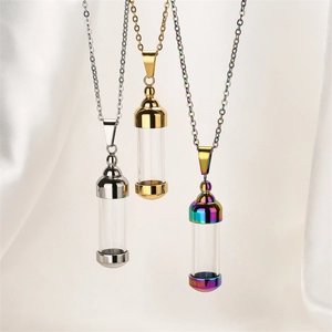 Detailed shot of openable perfume bottle necklaces in gold, silver and rainbow finishes