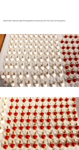Detail shot of vintage red and white enamel heart earrings in polished gold-plated finish