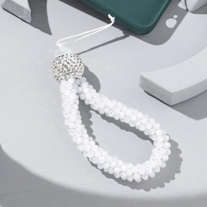 Detail of beaded phone wrist strap with white faceted beads and rhinestone ball accent